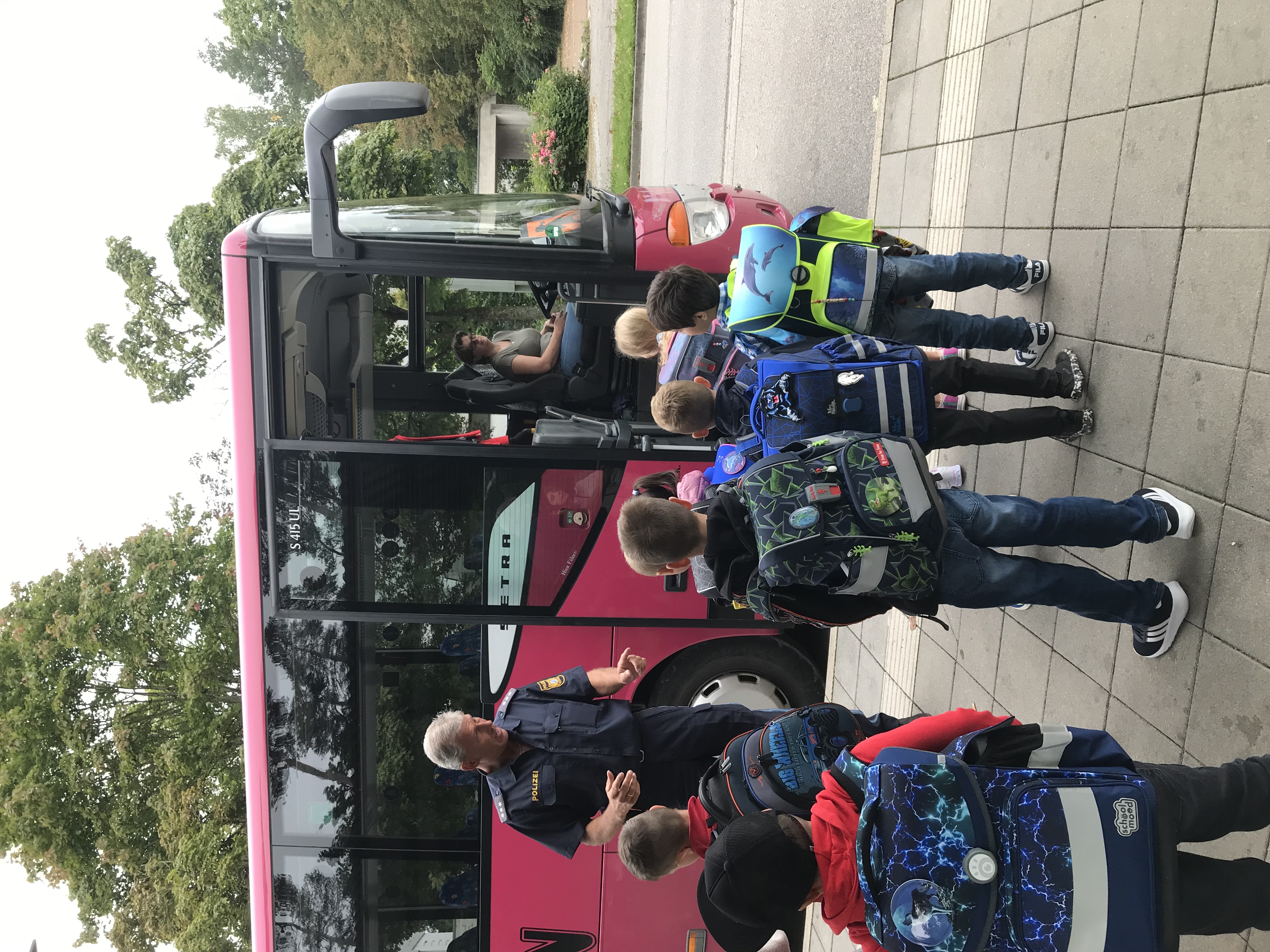 Aktionstag sicher Busfahren: Kinder stehen vor einem Bus